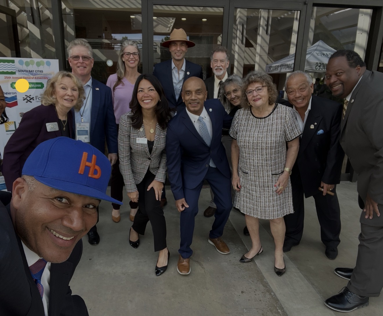 Ray Jackson with a group of community and business leaders outside a building.