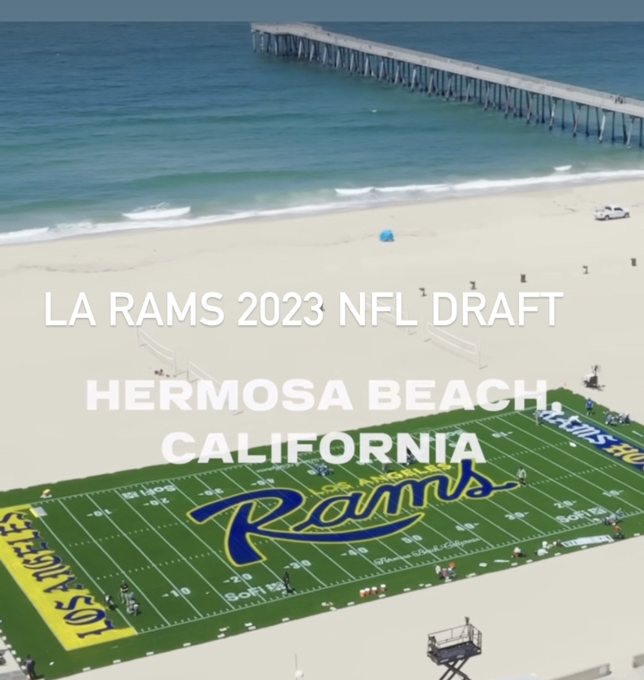 Aerial view of a football field on the beach promoting the LA Rams 2023 NFL Draft in Hermosa Beach.
