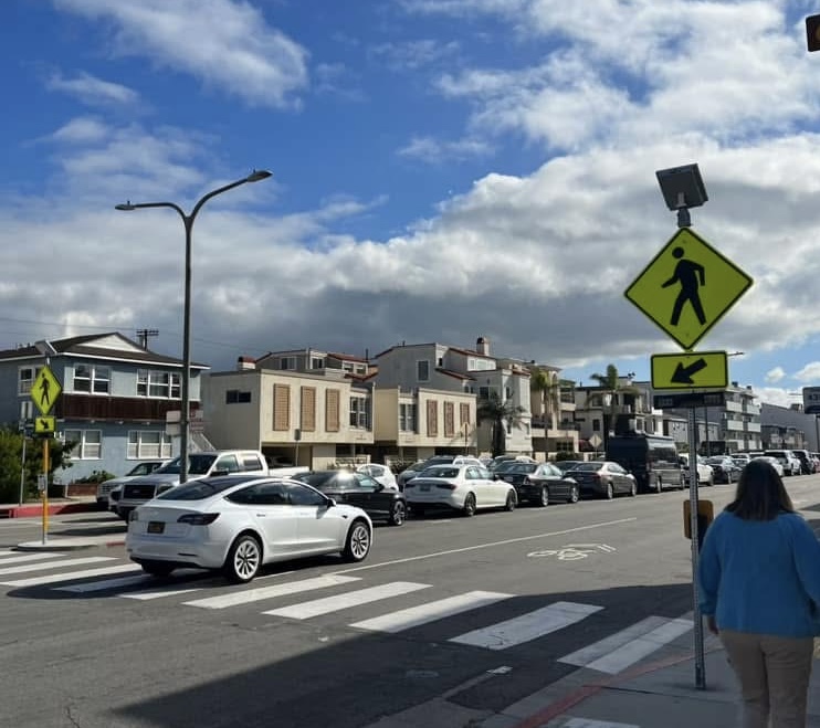 A street with a pedestrian crossing sign.